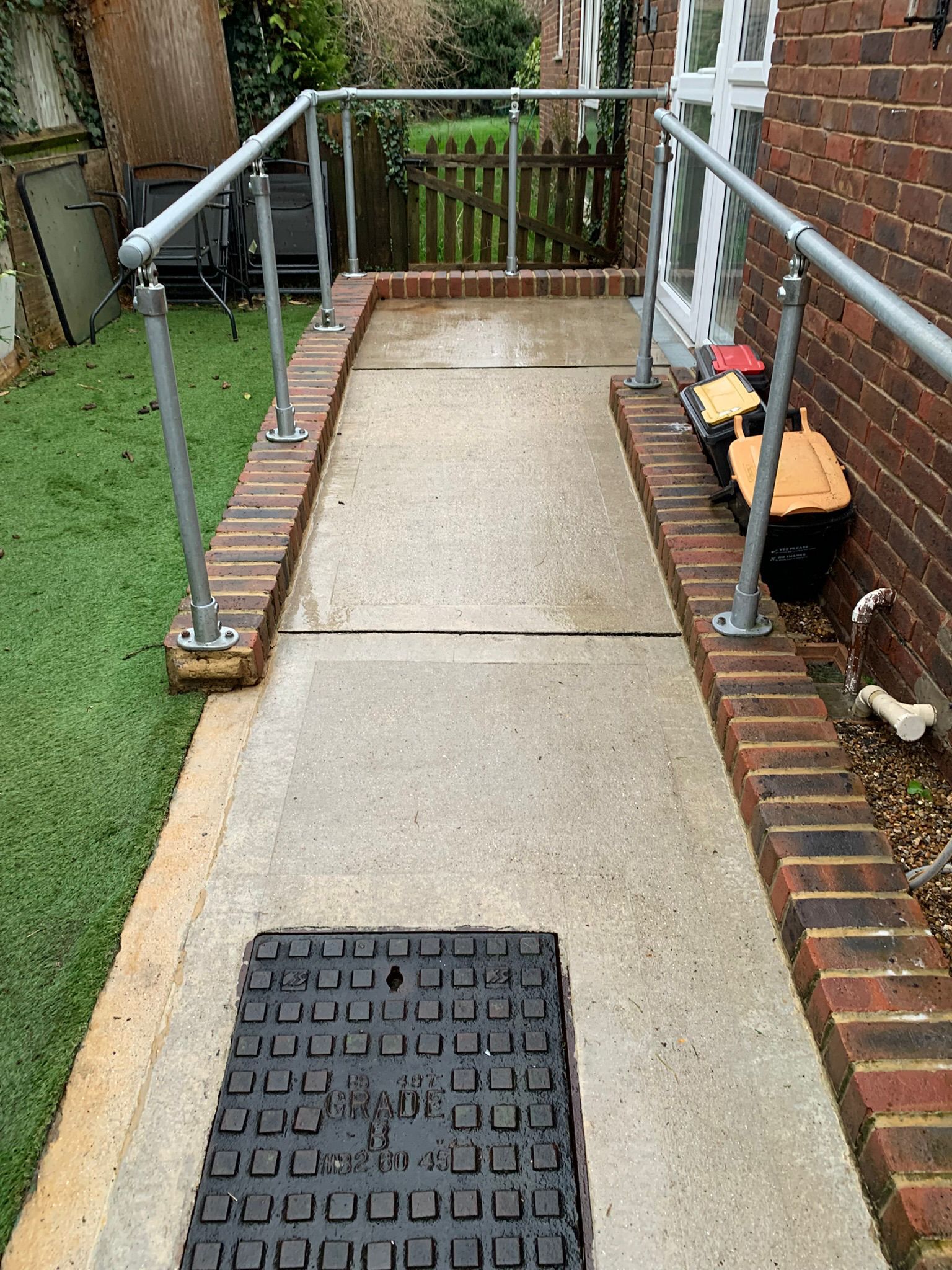 Concrete access path and ramp clean and safe after professional algae removal and pressure washing