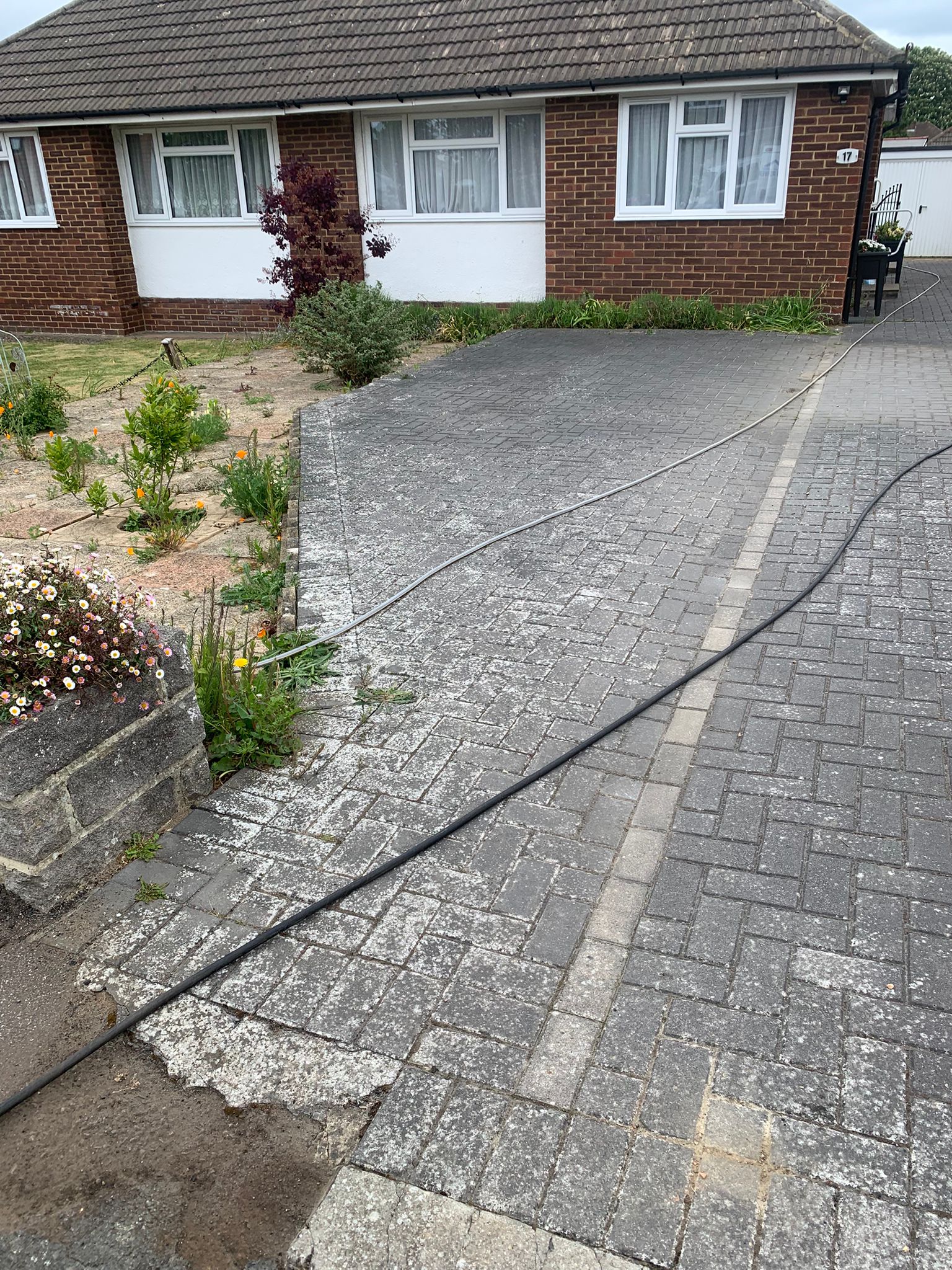 Block paving bungalow driveway dirty and stained before pressure washing in Kent